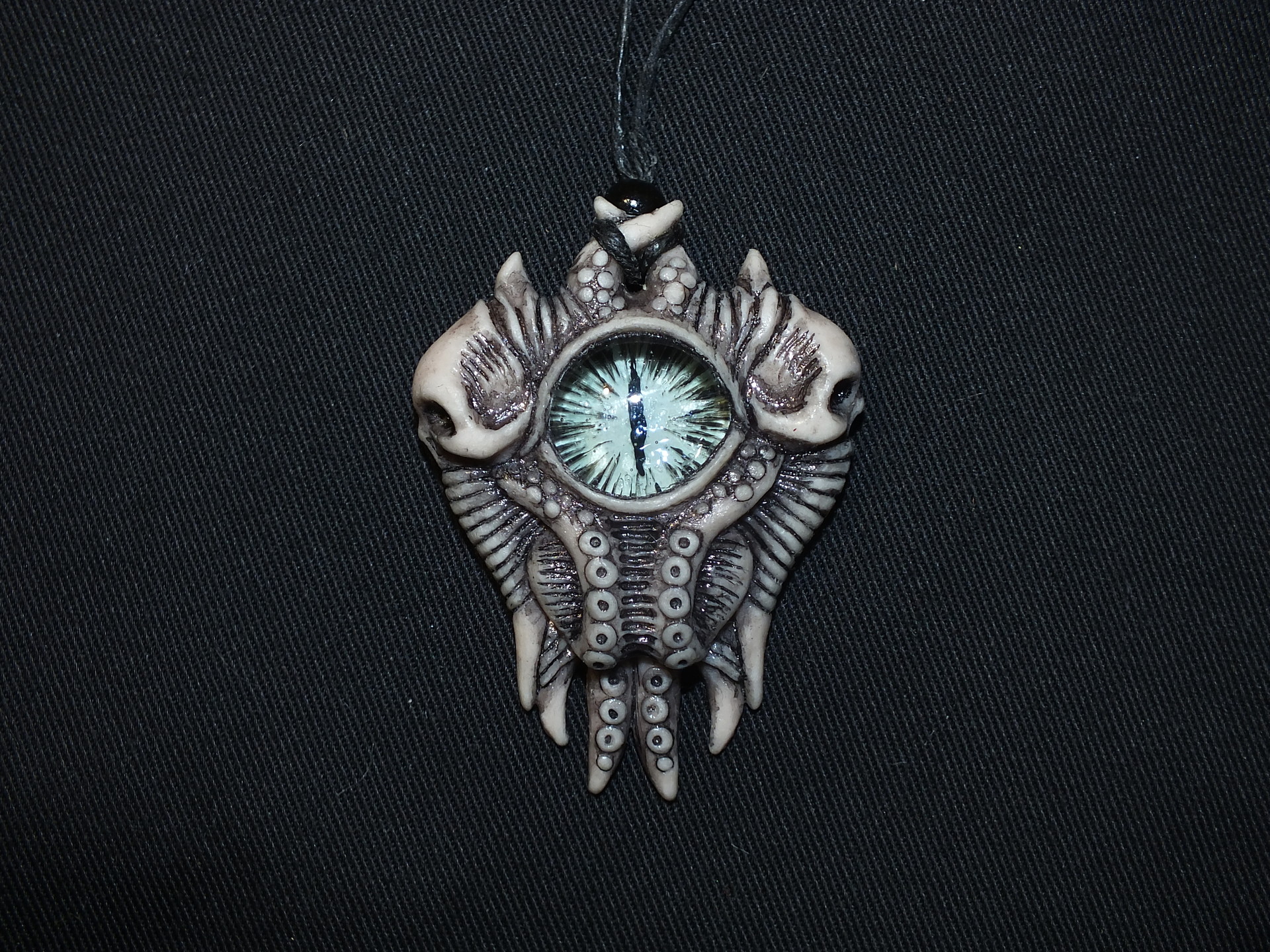 ArtStation - pendant with an eye and skulls
