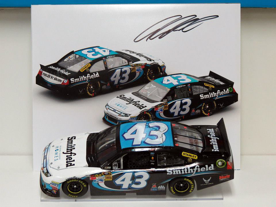 My own personal custom 1/24th scale 2012 #43 Smithfield diecast car along side an autographed copy of my original render for this scheme
