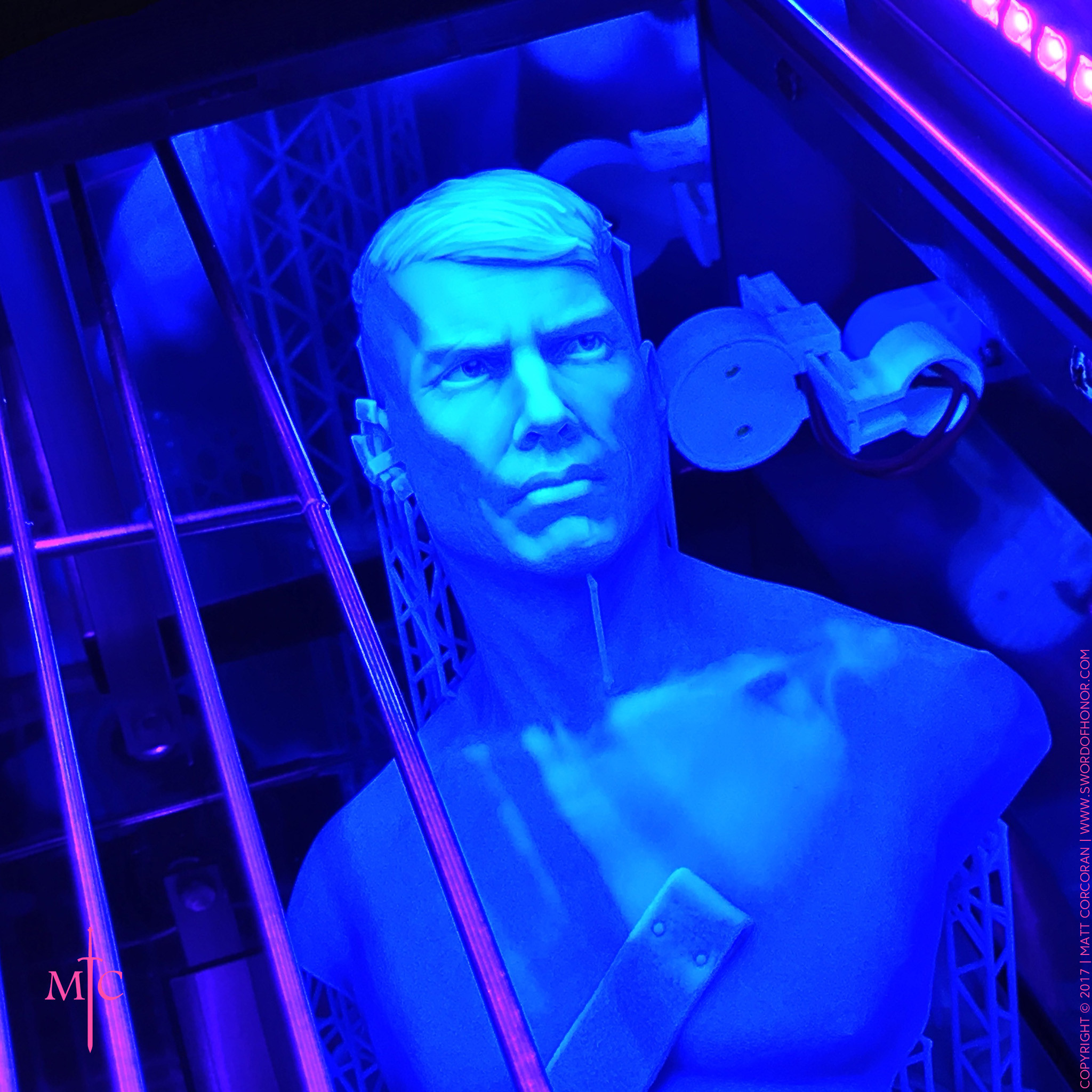 Bathing in ultra violet blue light. This UV light cures any uncured resin after printing and gives the resin some extra strength.