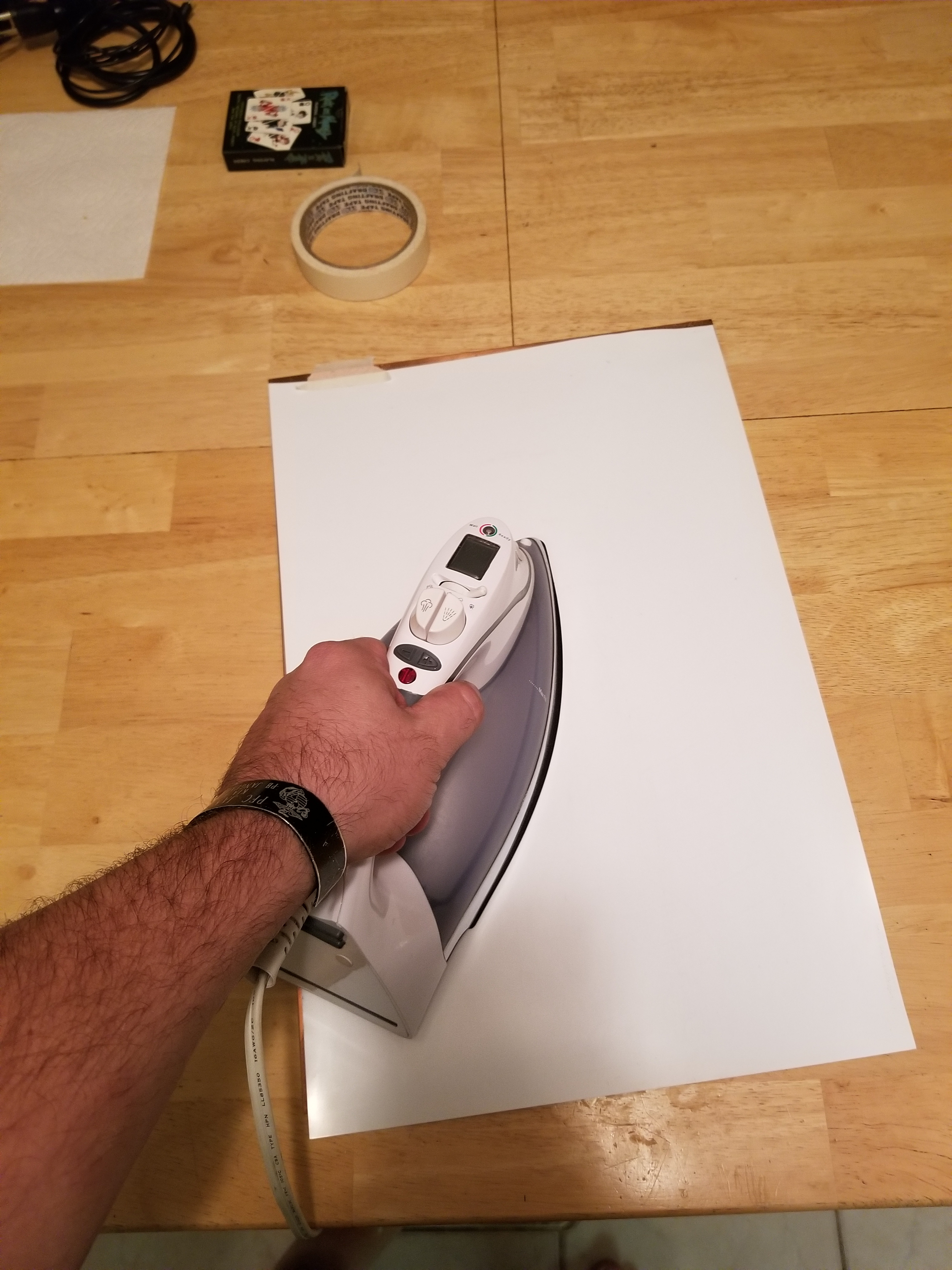 Ironing the back of the mylar sheet for approximately 5 minutes.