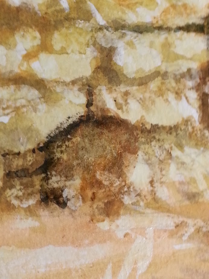 rocky texture that's produced with various brown to black tones over the scrumbled wax surface.