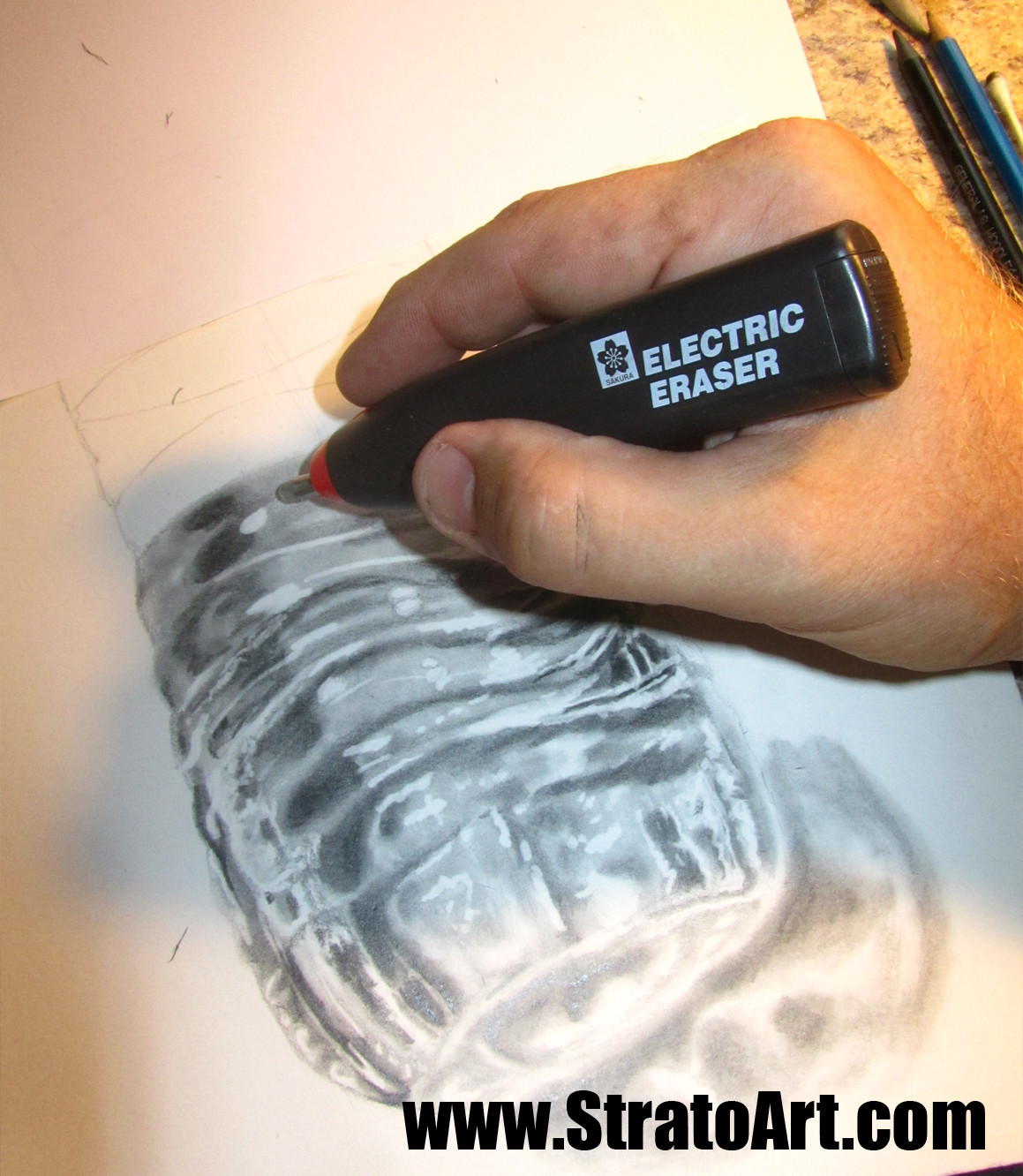 "lifting out" the highlights with my electric eraser. I love this tool!