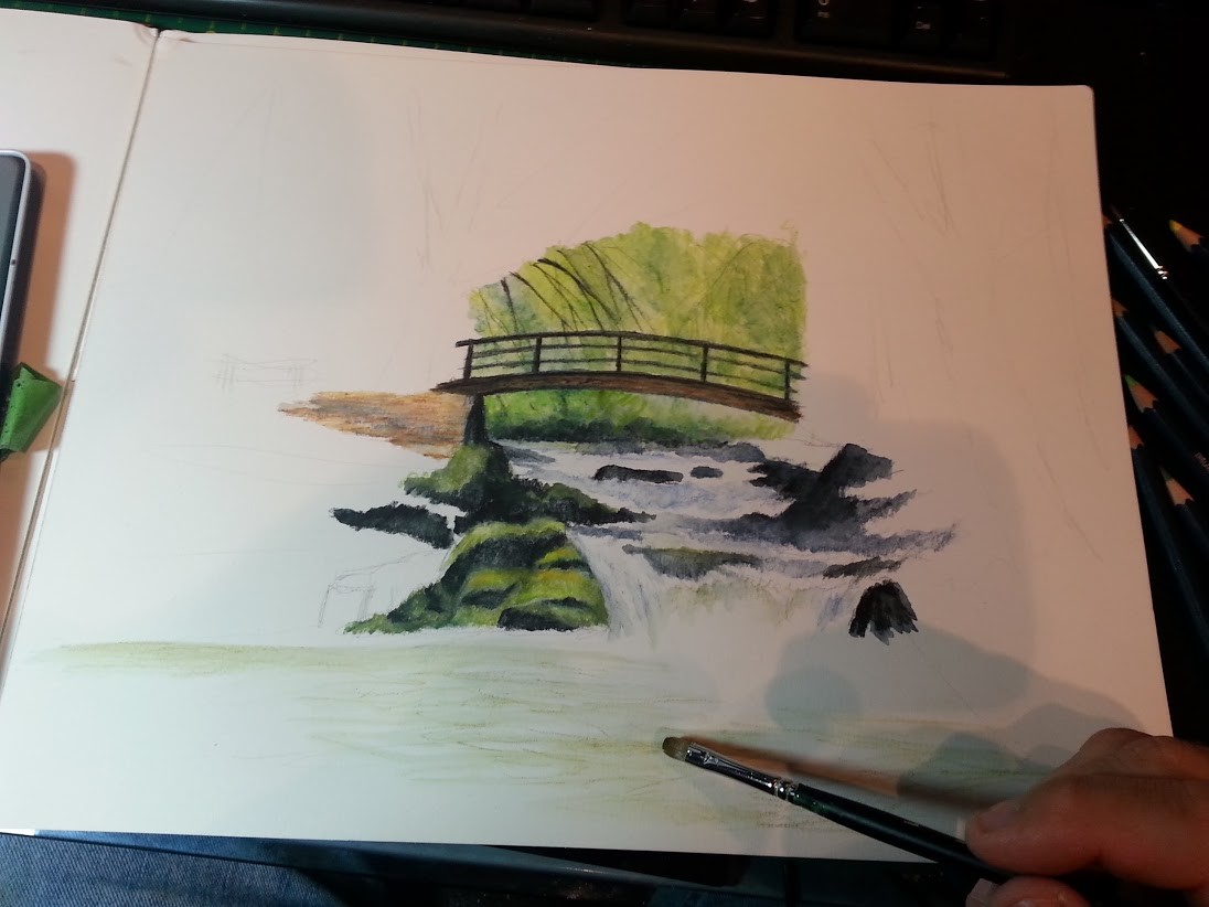 I produced very light strokes of the green watercolor pencil and then with a  small clean, wet filbert brush, I blend the green tones to produce accents on the water. I've already produced the green foliage behind the bridge, as well the bridge itself.