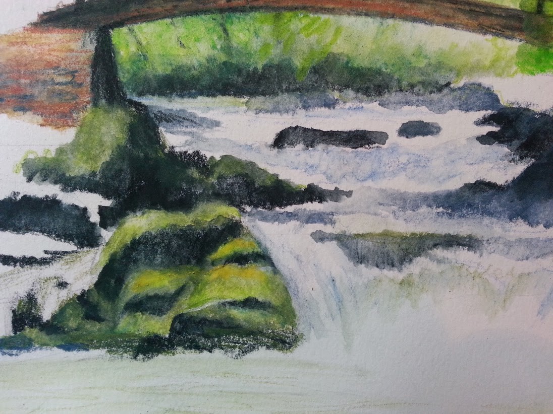 Detail of the mossy rocks below the bridge and the turbulent water