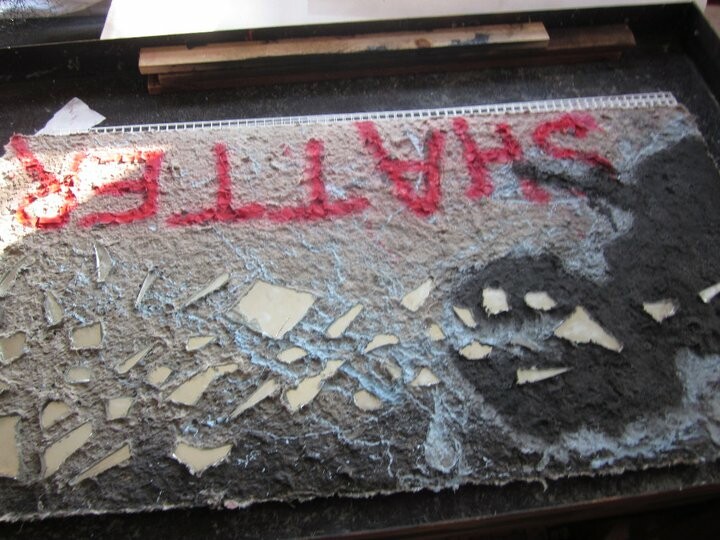 Collaborative large sheet with Eli Wright. Broken mirror fragments embedded in combat paper.