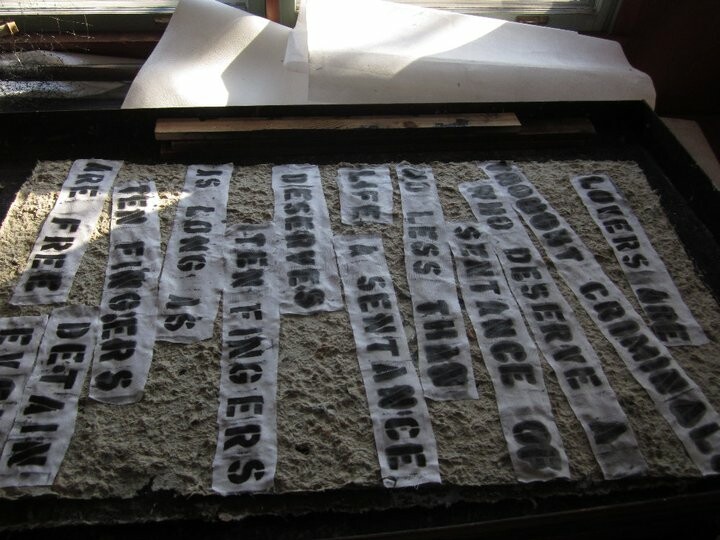 A stenciled poem embedded in Combat Paper.