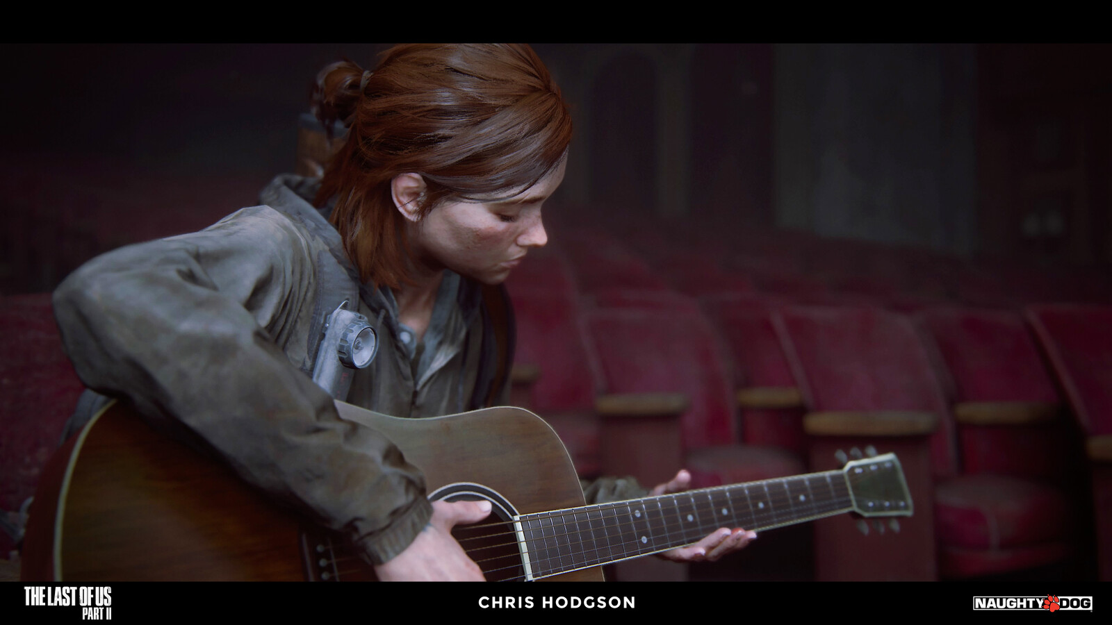 Ellie playing guitar inside the auditorium