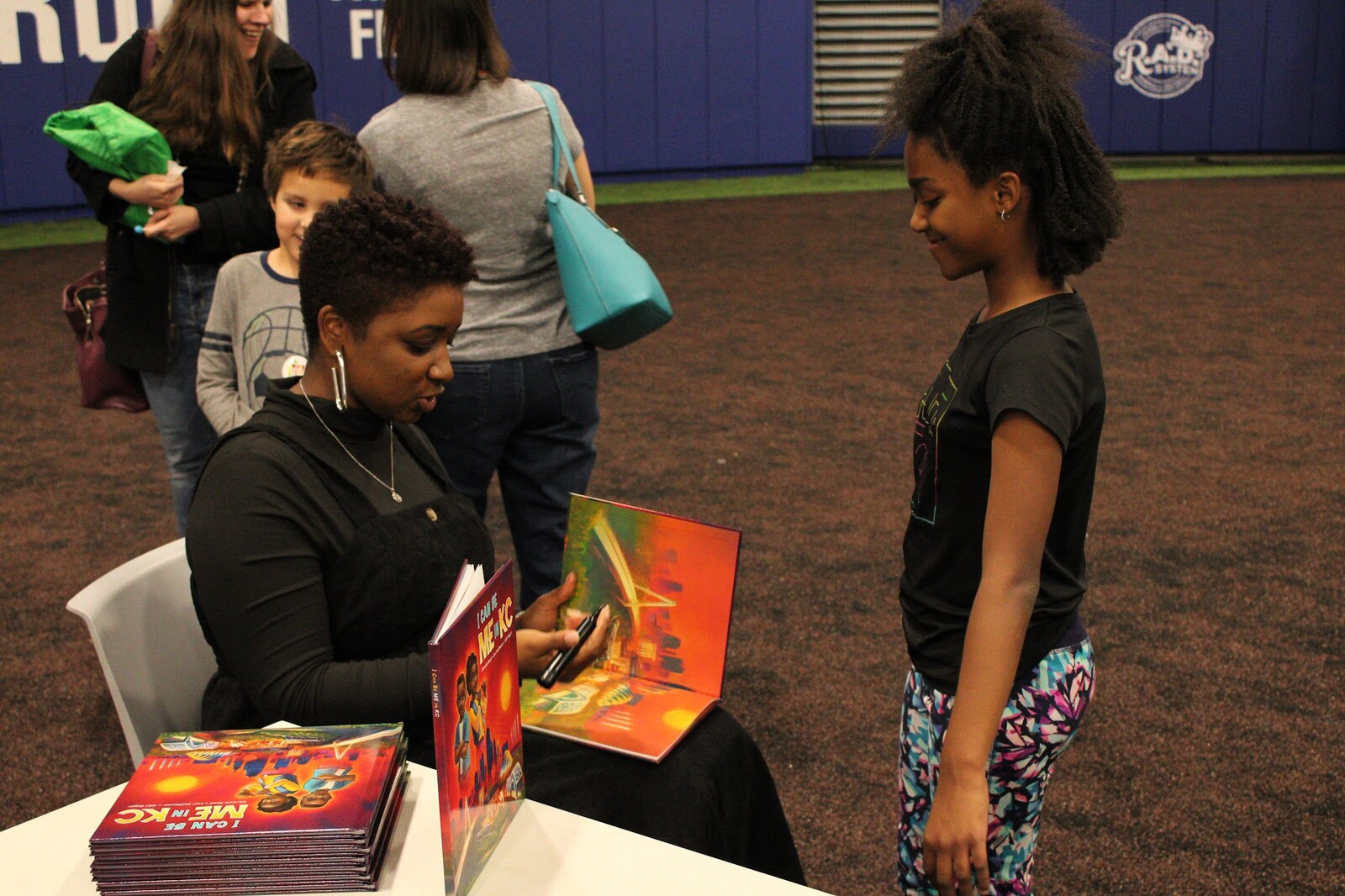 The writer signing a copy.