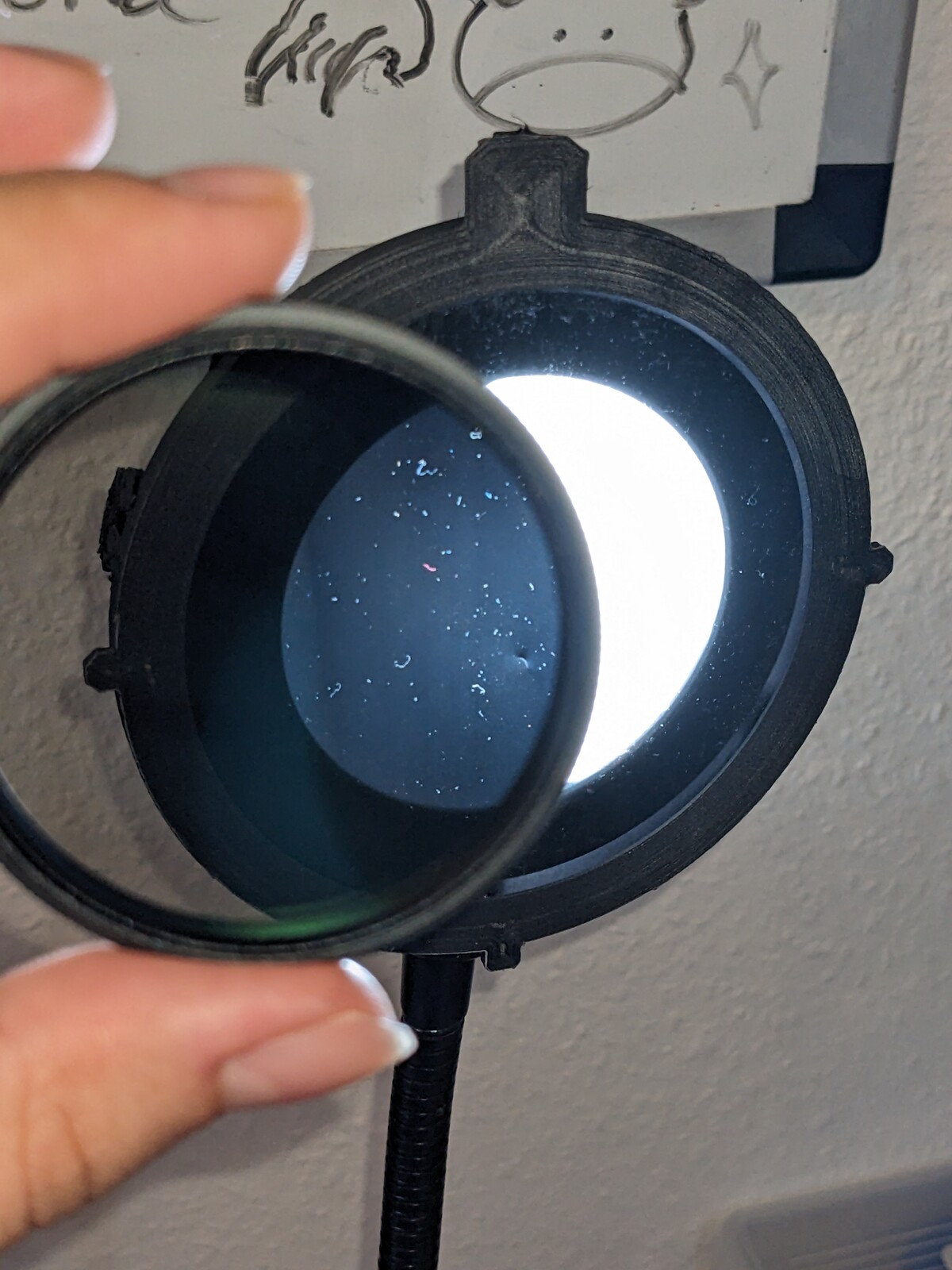 Cross-polarizing in action. The light is mostly filtered when going through both filters at 90° rotation.