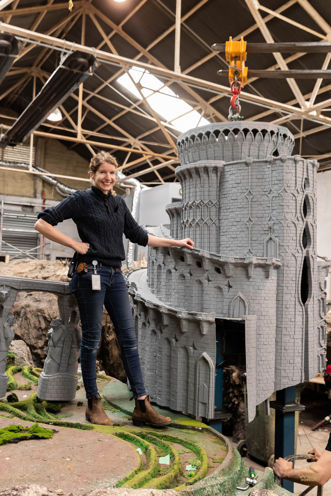 Project Supervisor Mona Peters stands with the final 3D printed piece. This was an assembly of around 20 SLA prints. 