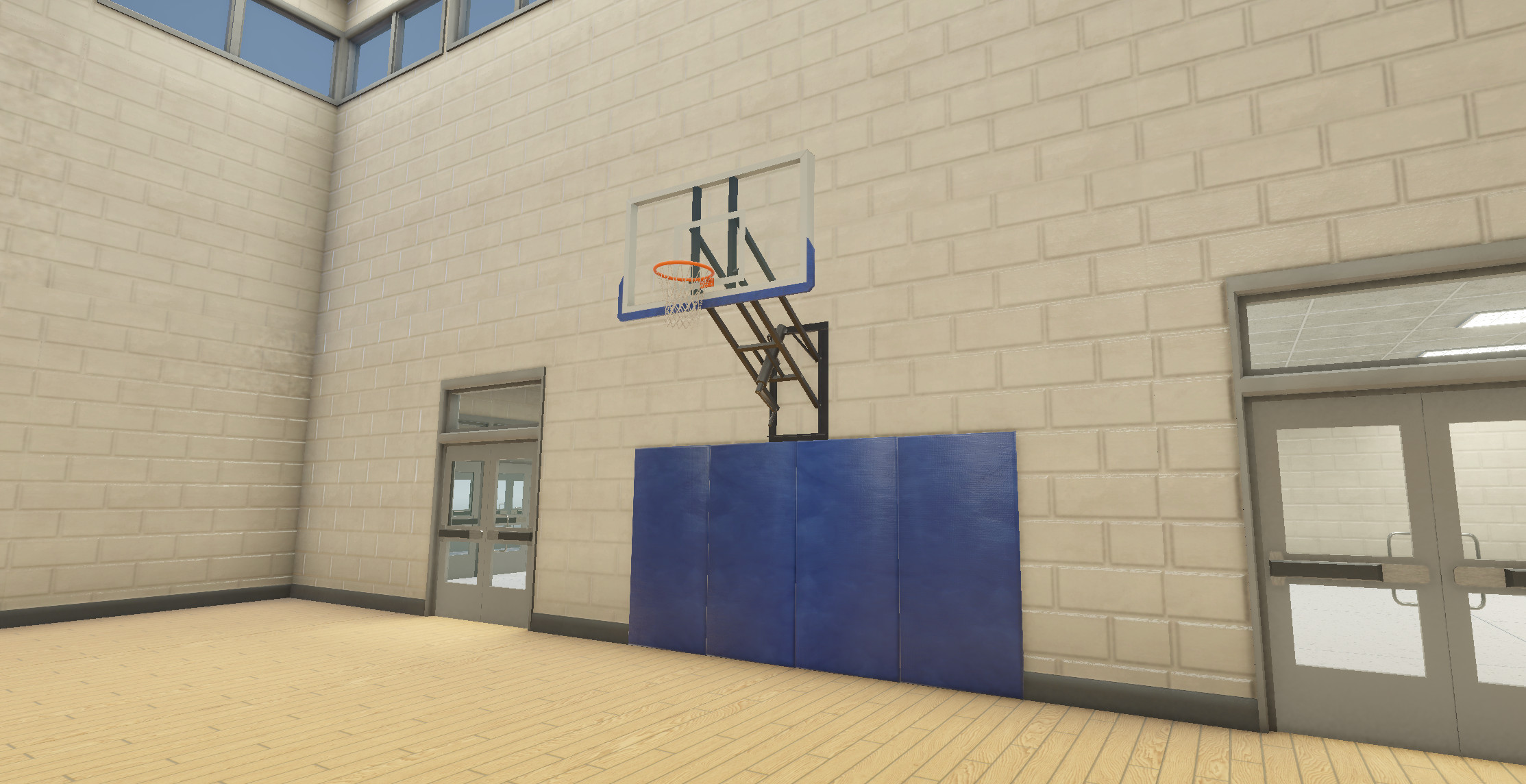 A closeup of the basketball hoop and protective wall mats.