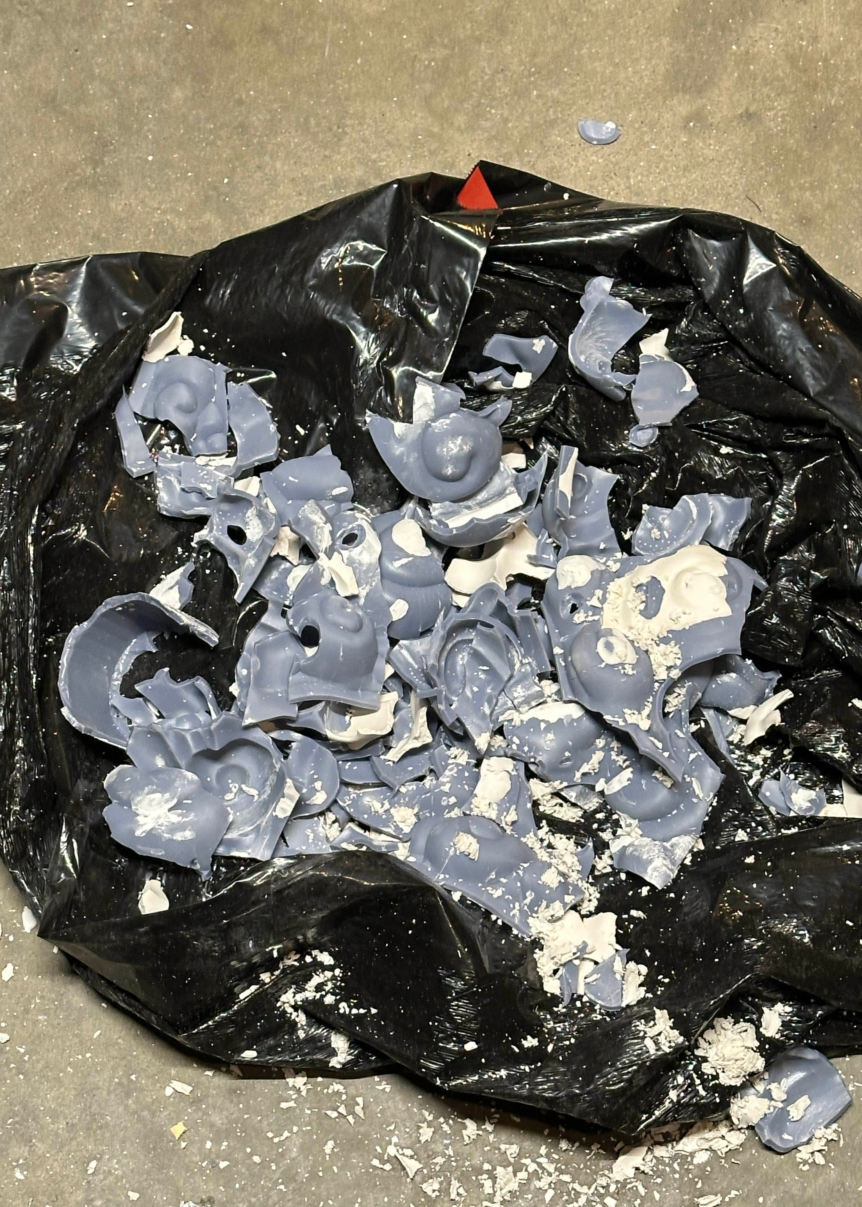 The remnants of the mold after breaking it apart to free the plaster cast.
