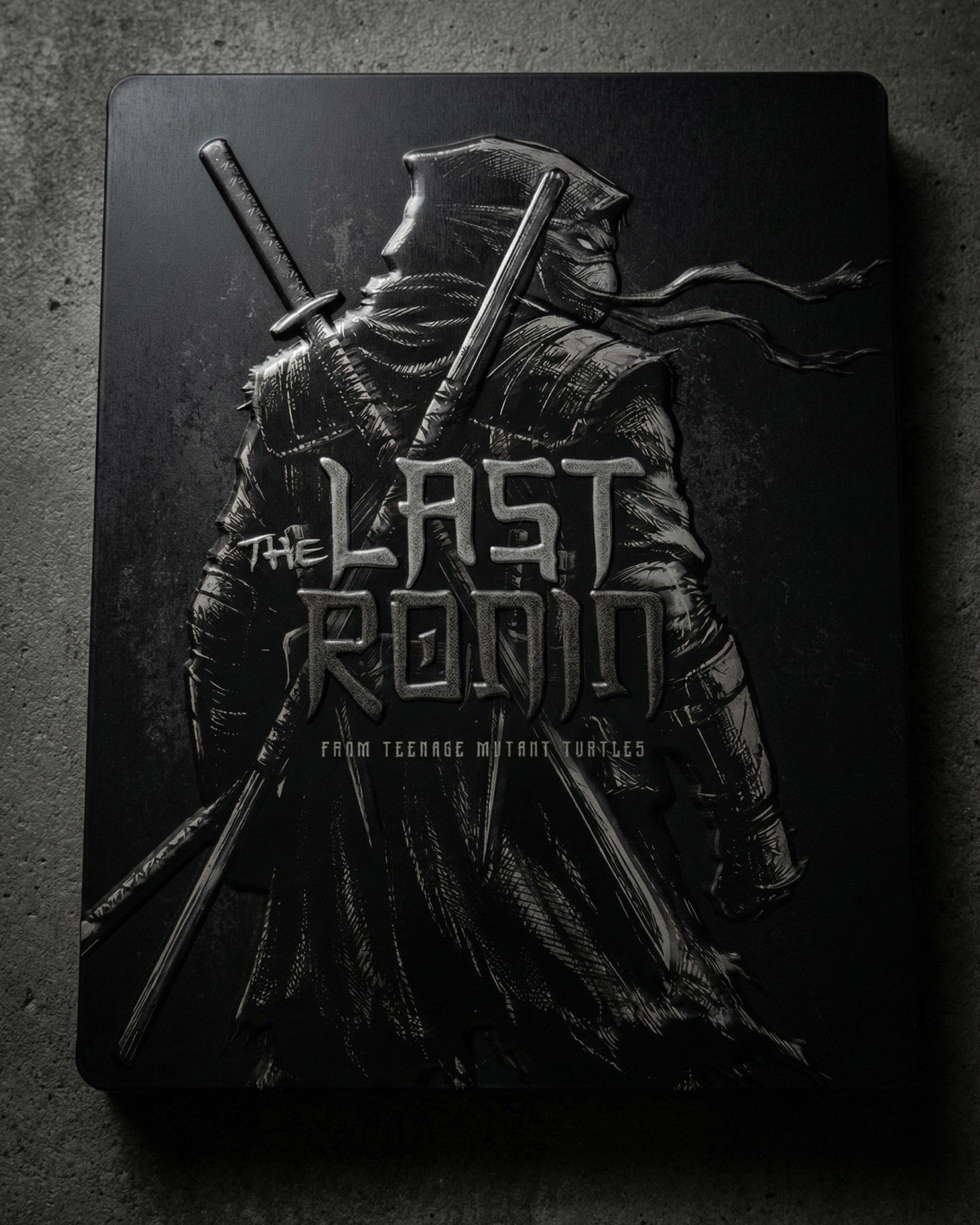 Front-facing steelbook design emphasizing material finish, lighting, and minimalist branding for a premium collector aesthetic