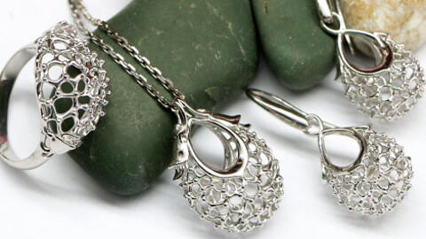 Jewelry set. Dainty models with openwork pattern without stones. Pendant, ring and earrings